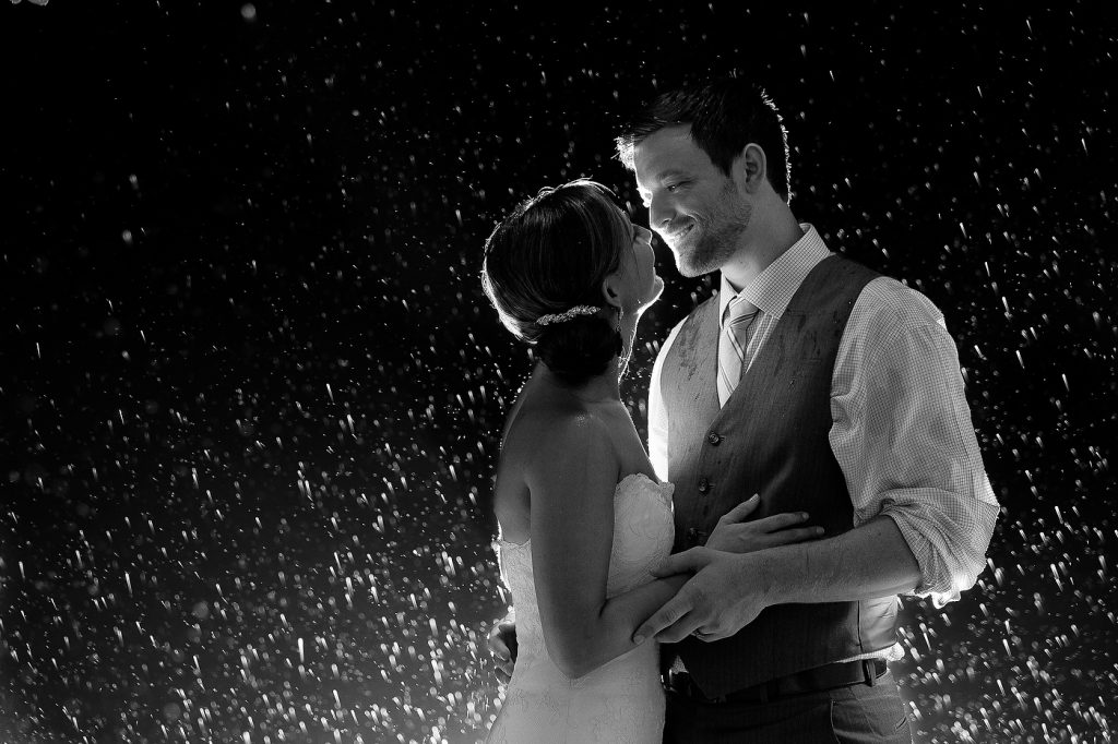 man and woman in the rain wedding day photos
